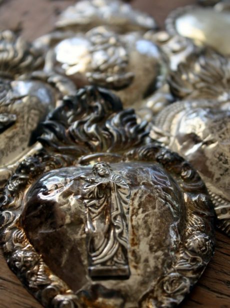 A collection of antique silver plated tin ex votos c.1890