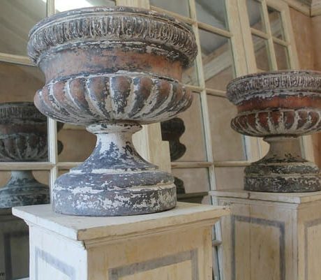 Pair of late Victorian urns sitting on later plinths