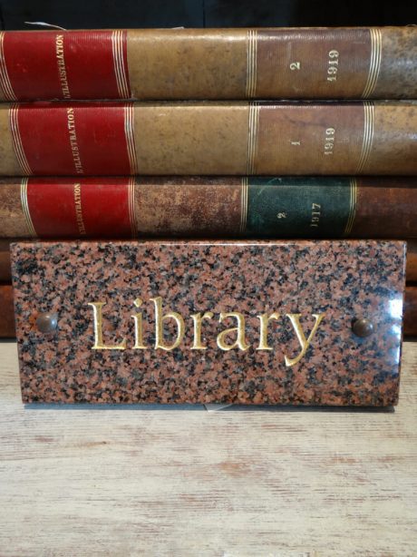 A granite public library building sign