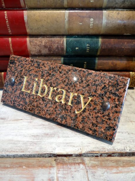 A granite public library building sign