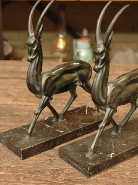 Pair of art deco spelter deers on marble plinths