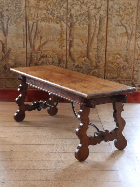 A Spanish antique oak and wrought iron coffee table