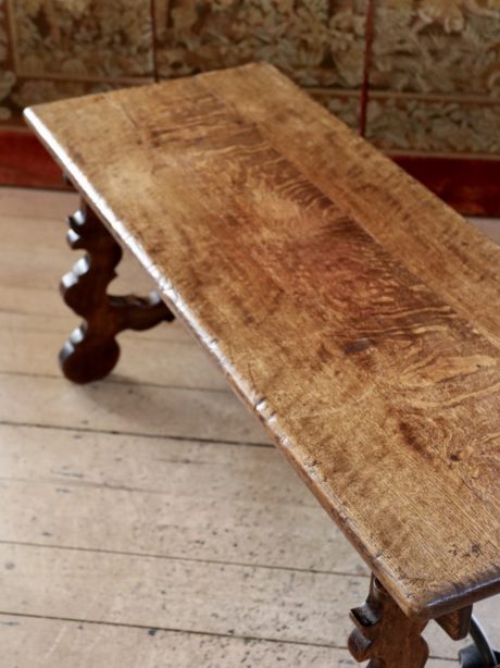 A Spanish antique oak and wrought iron coffee table