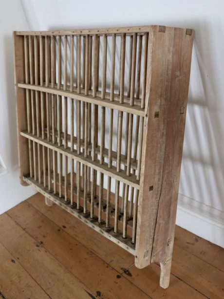 An early Victorian unwaxed pine wall plate rack