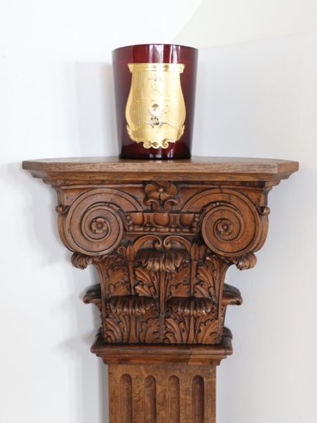 An antique carved oak corner corinthian display column