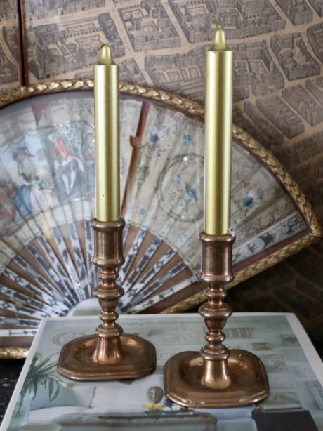 A pair of 18th century French red copper candlesticks